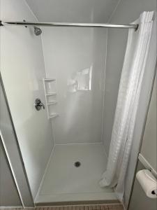 a shower in a bathroom with a shower curtain at 2400 Motel in Vancouver