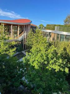 a building with a red roof and some trees at Skandinavisk City-lejlighed! in Odense