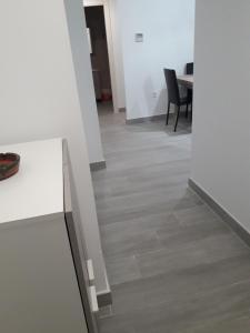 a hallway with white walls and wood floors at Apartamento Playa Blanca in Melilla