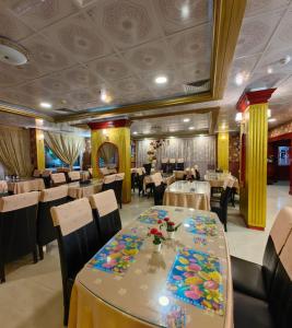 a dining room with tables and chairs in a restaurant at San Marino Hotel in Dubai