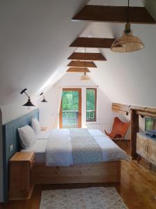 a bedroom with a large bed and a window at Chalet Poarta in Bran