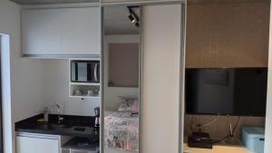 um quarto com uma cozinha e uma televisão num quarto em VN Bom Retiro em São Paulo