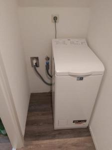 a small refrigerator in a corner of a room at Wohnung Sonnenschein Wolgast in Wolgast +39 photos