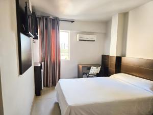 Cama ou camas em um quarto em CLH Suítes Foz do Iguaçu