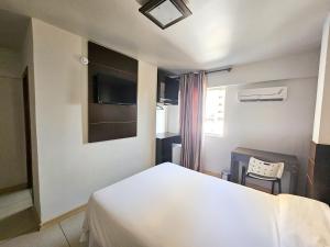 Cama ou camas em um quarto em CLH Suítes Foz do Iguaçu