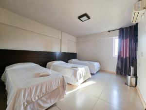 Cama ou camas em um quarto em CLH Suítes Foz do Iguaçu