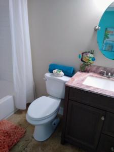 a bathroom with a white toilet and a sink at Million Dollar Lake View in Orlando