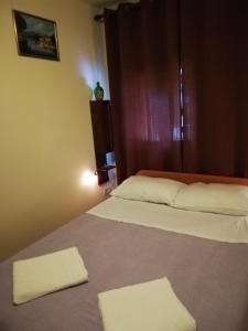 a bedroom with two white towels on a bed at Apartment Haldej in Mošćenička Draga