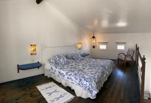 a bedroom with a bed and two chairs in it at Finca Angelus Amazing Views Sea + Teide in La Matanza de Acentejo