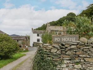 a stone wall with a no house sign in front of a building at The Chapel in Millom