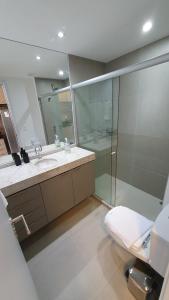 a bathroom with a toilet and a sink and a shower at Flat Boa Viagem - Rooftop 470 in Recife