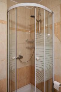 a shower with a glass enclosure in a bathroom at Studios Ruža in Baška Voda +105 photos