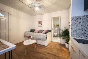 a small bedroom with a bed and a table at Le petit Arth&M Clermont Ferrand in Clermont-Ferrand