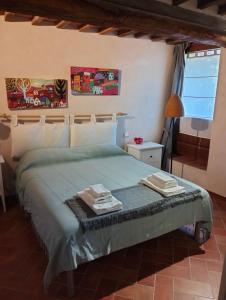 Ein Bett oder Betten in einem Zimmer der Unterkunft Agli Olivi di Marciano
