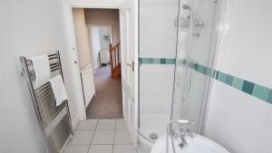 a bathroom with a shower and a toilet and a sink at Oakland Road, Mumbles in The Mumbles +24 photos