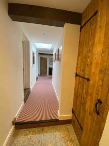 a hallway with a large wooden door and a floor at Stylish 3 bedroom apartment in historic city centre building in Sheffield