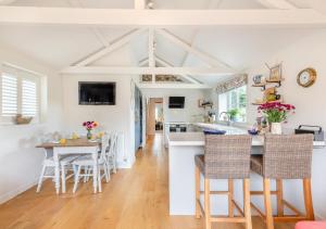 a kitchen and dining room with a table and chairs at Appletree Cottage in Thornage