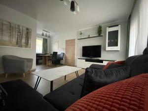 a living room with a couch and a table at Haus Anton 
