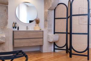 a bathroom with a sink and a mirror at Ando Living - Flores 200 House in Porto +291 photos