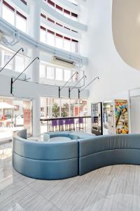 a lobby with a blue couch in a building at Single Inn - Taipei in Taipei