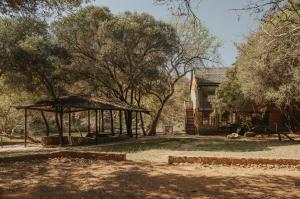 a building with a gazebo and a house at Wilgeboomsdrift Safaris in Modimolle