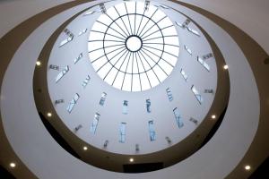 a spiral staircase in a building with a glass ceiling at Dolce by Wyndham Milan Malpensa in Somma Lombardo