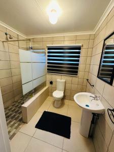 a bathroom with a toilet and a sink at 6 the Curve Unit 12 in Johannesburg