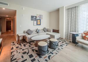 a living room with a couch and a table at Cambria Hotel Austin Downtown in Austin