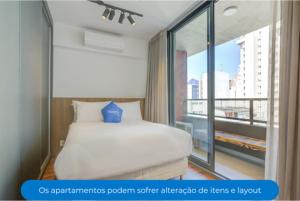a bedroom with a bed and a large window at Roomo OY Frei Caneca Residencial in São Paulo