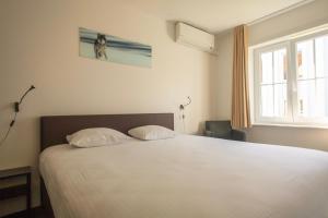 Voodi või voodid majutusasutuse St-Janshof Hotel toas