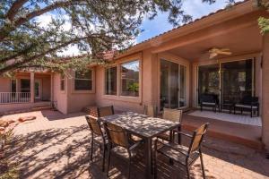 a patio with a table and chairs in front of a house at West Sedona Retreat in Sedona