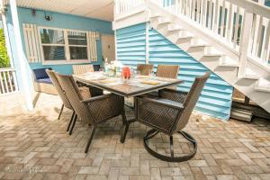 a dining table and chairs on a patio at No-Stairs Beach Getaway - Ground Floor Pet-Friendly 2BR in Fort Pierce
