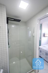 a shower with a glass door in a bathroom at Studio a 150m da praia de Piatã in Salvador