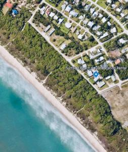 an aerial view of a beach and the ocean at Steps to Private Beach - Sand, Surf, Sun - 2bd,2ba in Fort Pierce