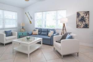 a living room with a couch and a table and chairs at Upper-Floor Ocean Breeze - Surf Views 2BR in Fort Pierce