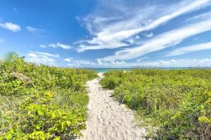 a path through a beach with the ocean in the background at Upper-Floor Ocean Breeze - Surf Views 2BR in Fort Pierce