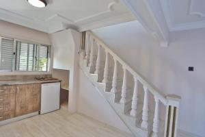 a staircase in a home with white walls and wooden floors at House w Pool Balcony 5 min to Beach in Kyrenia in Kyrenia