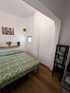 a bedroom with a bed and a chair in it at Alghero, old town in Alghero +16 photos