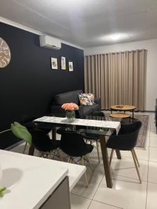 a living room with a table and a couch at Yula Apartments in Windhoek