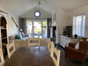 a living room with a table and a living room with a couch at Blue Bay at The Bay Filey, sleeps 4-6, 2 dogs welcome for free too in Filey
