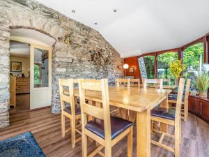 a dining room with a wooden table and chairs at Eden Mill, Millers Beck in Kendal