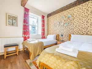 a hotel room with two beds and a window at Eden Mill, Millers Beck in Kendal