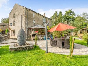 a patio with an umbrella and a table and chairs at Eden Mill, Millers Beck in Kendal +36 photos