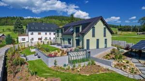 - une vue aérienne sur une maison avec un jardin dans l'établissement CHALET HOUBOVÝ VRCH, à Horní Planá