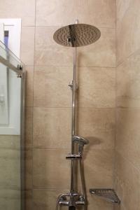 a shower with a lamp on top of a shower stall at AIOLOS GLYFADA luxury sea view suite 5 in Athens