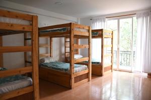 three bunk beds in a room with a window at Zoila's Suite Escape in Nuevo Tingo