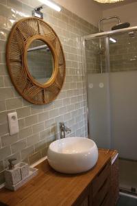 a bathroom with a white sink and a mirror at Gîte 4 étoiles avec SPA privatif in Méaulte