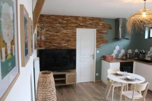 a kitchen with a table and a kitchen with a dining room at Gîte 4 étoiles avec SPA privatif in Méaulte