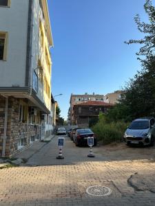 a street with cars parked on the side of a building at Well Hotel Edirne in Edirne