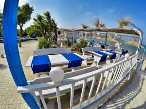 a group of blue and white tables and umbrellas at Guest House Gabriel in Sozopol